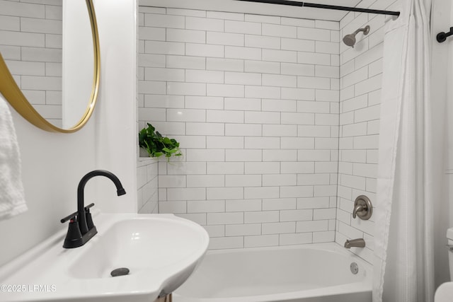 bathroom with shower / tub combo and sink