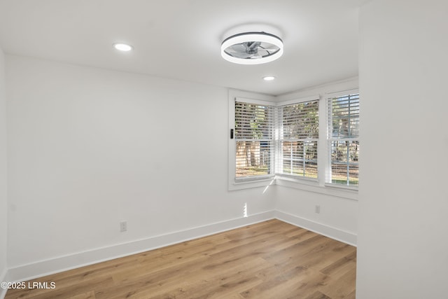 spare room featuring hardwood / wood-style flooring and a healthy amount of sunlight