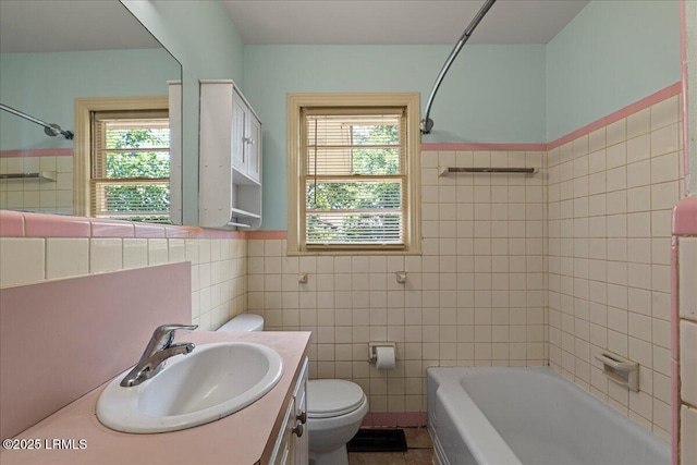 1803 Sixth St, Beaufort, SC 29902 - bathroom with tile walls, plenty of natural light, vanity, bathtub / shower combination, and a wainscoted wall