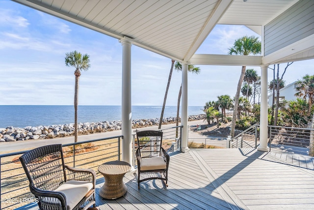 deck with a water view and a view of the beach