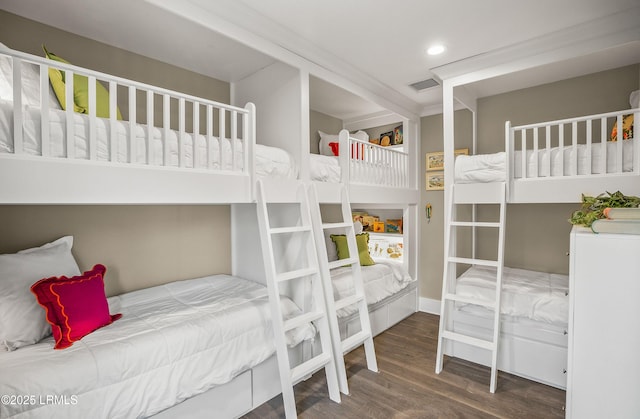 bedroom with dark wood-style flooring, visible vents, and recessed lighting