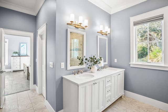 full bathroom with marble finish floor, ornamental molding, and a sink