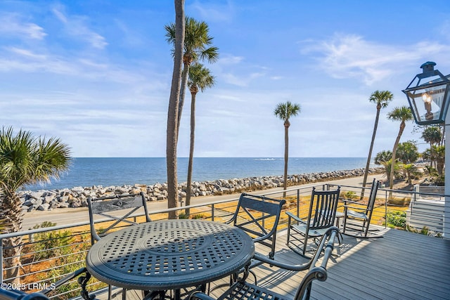 wooden deck featuring a water view and a beach view