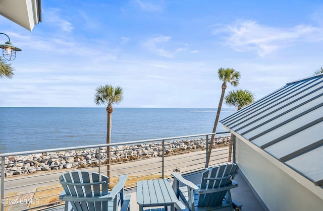 balcony with a beach view and a water view