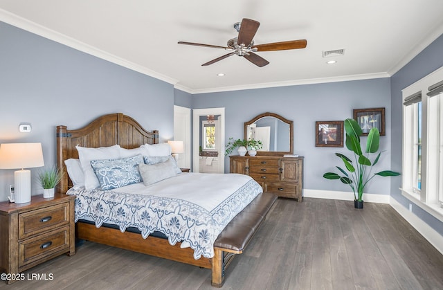 bedroom featuring dark wood-style flooring, crown molding, visible vents, a ceiling fan, and baseboards