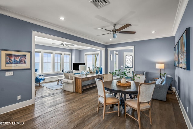 dining area featuring crown molding, dark wood-type flooring, visible vents, and baseboards