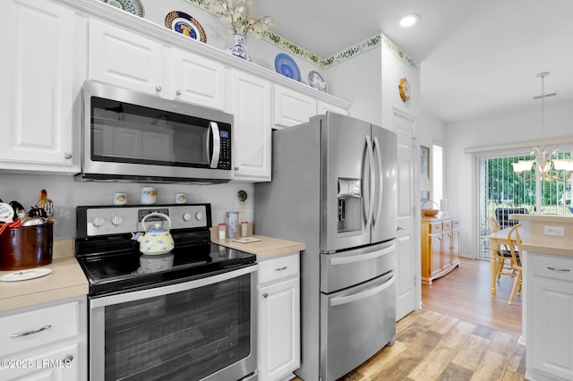 kitchen with white cabinets, appliances with stainless steel finishes, and light countertops