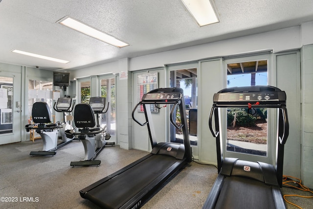 workout area featuring a textured ceiling