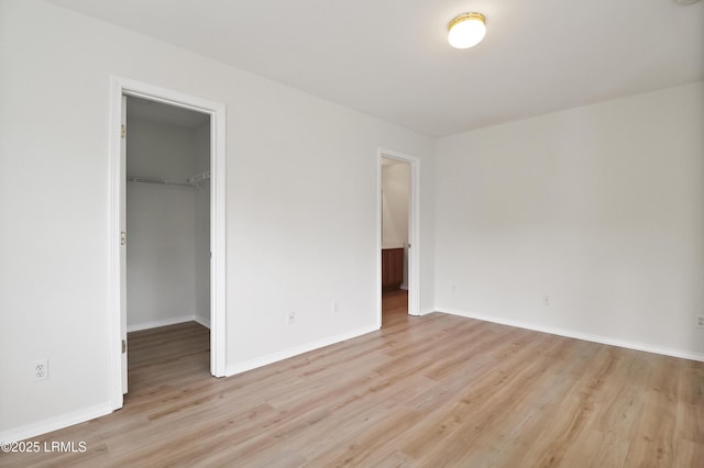 300 Campus Ln, Okatie, SC 29909 - unfurnished bedroom featuring light wood-style flooring, a spacious closet, and baseboards