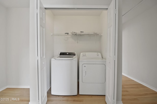 300 Campus Ln, Okatie, SC 29909 - laundry area with washer and clothes dryer, light wood-style floors, and baseboards