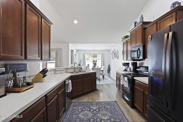 2110 River Rock Way, Beaufort, SC 29902 - kitchen with black appliances, wood finished floors, a peninsula, light countertops, and recessed lighting