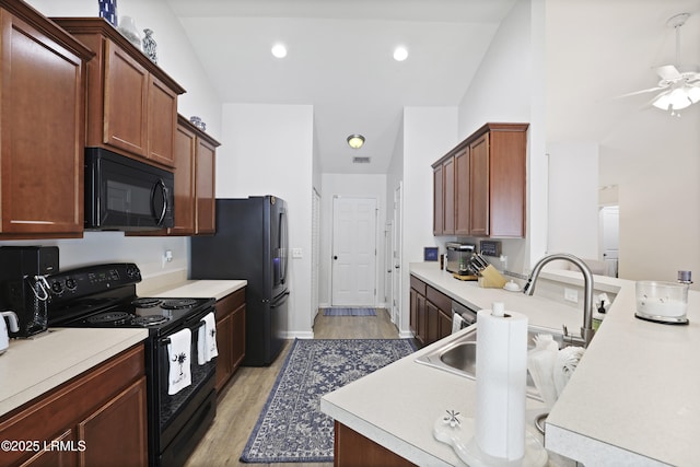 2110 River Rock Way, Beaufort, SC 29902 - kitchen with black appliances, ceiling fan, light wood-style flooring, light countertops, and lofted ceiling