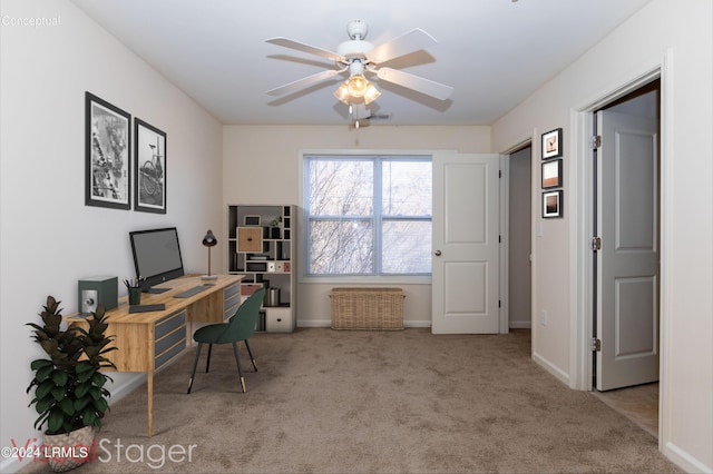 carpeted office space featuring ceiling fan