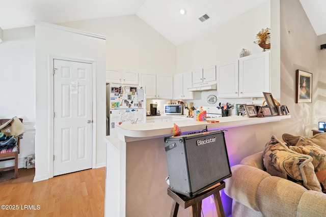 kitchen featuring white cabinetry, light hardwood / wood-style floors, kitchen peninsula, and white refrigerator