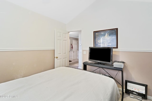 bedroom featuring lofted ceiling and carpet floors