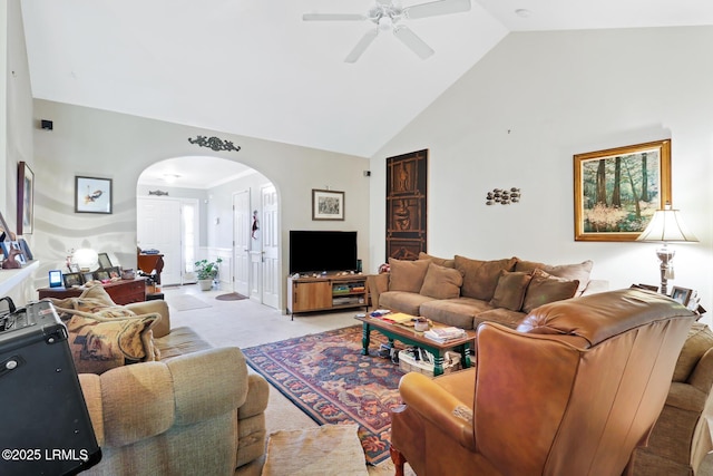 carpeted living room featuring ceiling fan and high vaulted ceiling