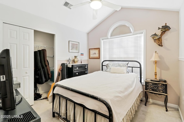 bedroom with lofted ceiling, light carpet, a closet, and ceiling fan