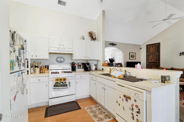 kitchen featuring lofted ceiling, white cabinets, kitchen peninsula, white appliances, and light hardwood / wood-style flooring