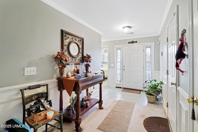 entrance foyer with light tile patterned flooring and ornamental molding