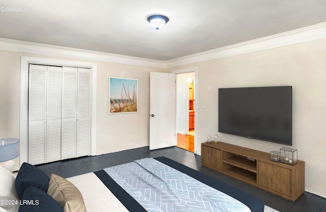 bedroom featuring crown molding, a closet, and dark tile patterned floors