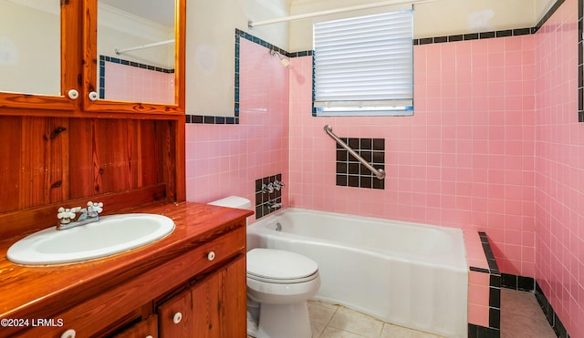 full bathroom featuring tile walls, tiled shower / bath combo, vanity, toilet, and tile patterned floors