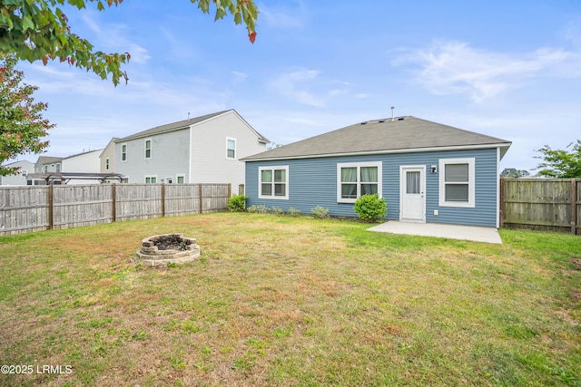 42 Pacolet Ln, Beaufort, SC 29906 - rear view of house featuring a yard, a fenced backyard, a fire pit, and a patio area