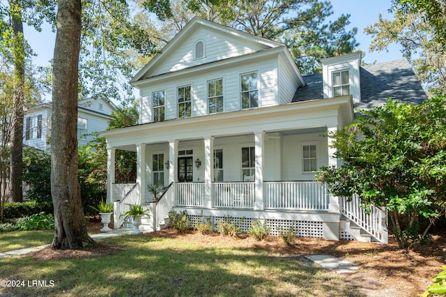 greek revival house with a front lawn and covered porch