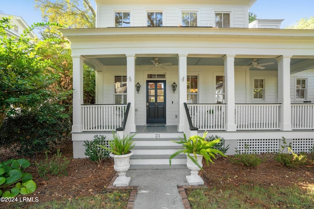 view of exterior entry with ceiling fan and a porch