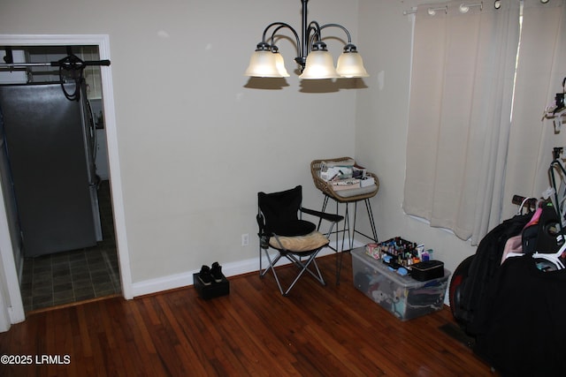 living area featuring baseboards and wood finished floors