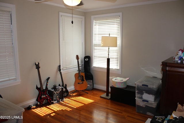 game room with ceiling fan, crown molding, baseboards, and wood finished floors