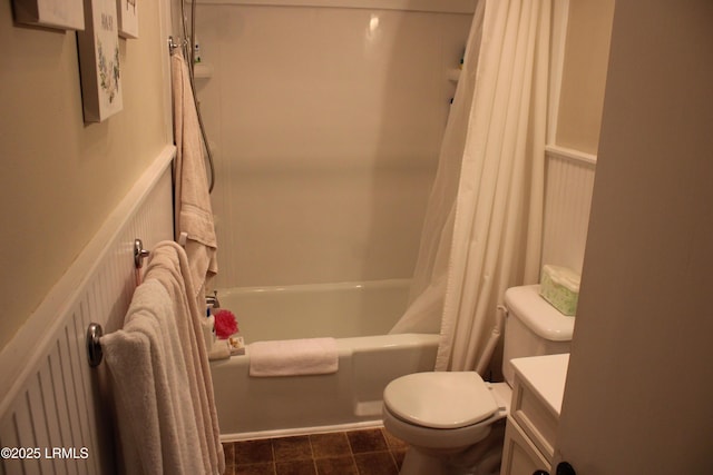 bathroom featuring toilet, shower / bath combination with curtain, and vanity