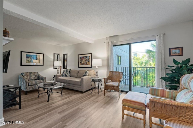 34 S Forest Beach Dr Unit B12, Hilton Head Island, SC 29928 - living room featuring a textured ceiling and light wood-style flooring