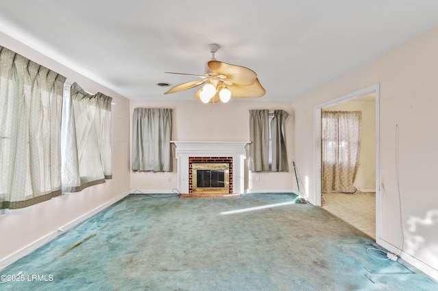 unfurnished living room with a fireplace, ceiling fan, and carpet flooring