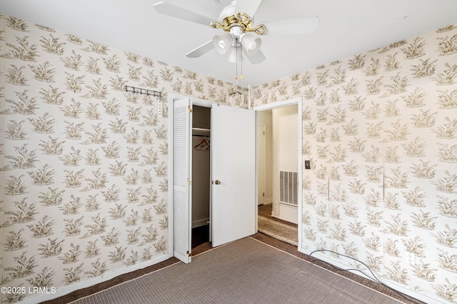 carpeted empty room with ceiling fan