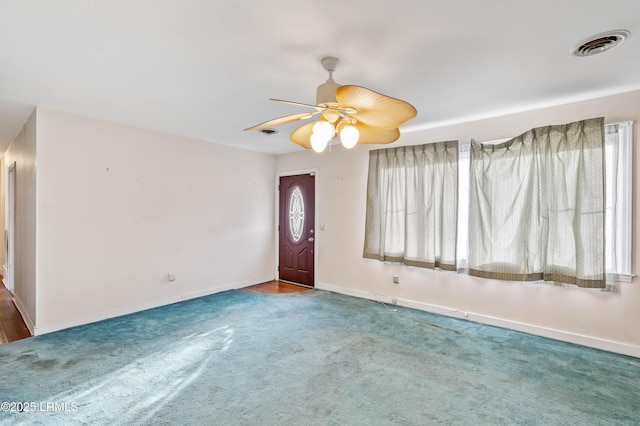 carpeted entryway with ceiling fan