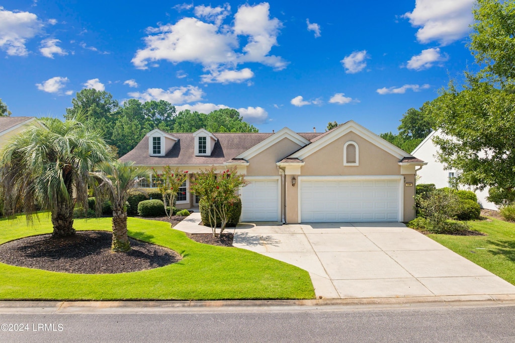 view of front facade featuring a garage and a front lawn