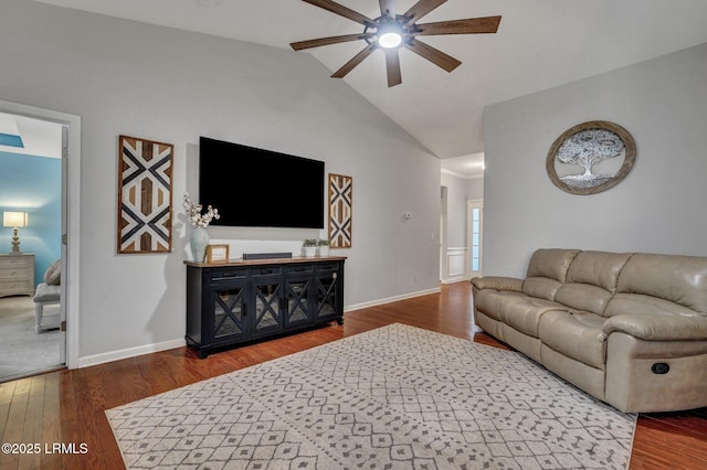 living room with lofted ceiling, wood finished floors, and baseboards