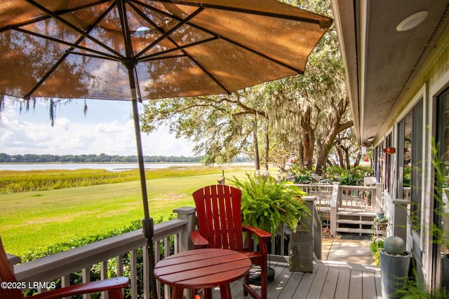 deck featuring a water view and a yard