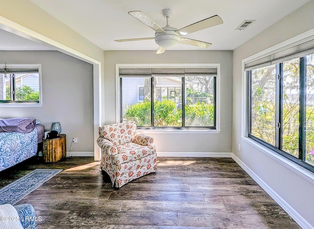 sitting room with wood finished floors, ceiling fan, and baseboards
