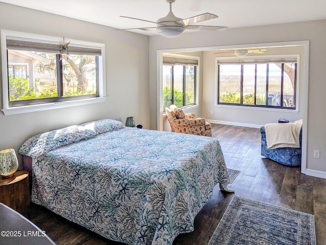 bedroom featuring wood finished floors, baseboards, and ceiling fan