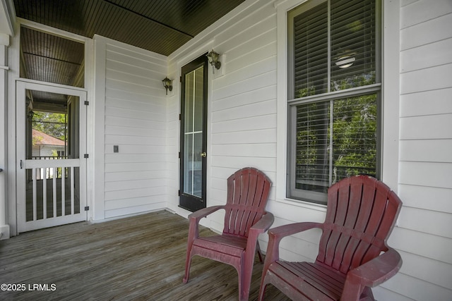 wooden terrace featuring covered porch