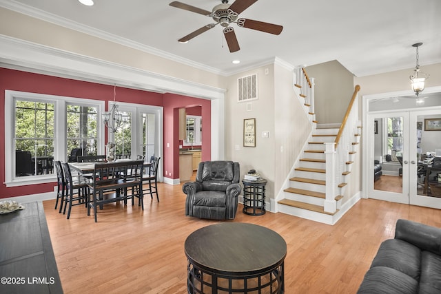 living room featuring wood finished floors, french doors, a ceiling fan, crown molding, and visible vents