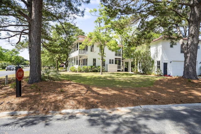 view of front of house featuring an attached garage and a front lawn