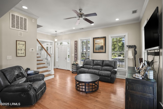 living area with wood finished floors, a ceiling fan, stairs, visible vents, and recessed lighting