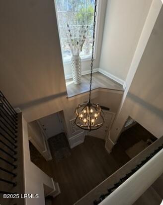 interior space featuring a chandelier, baseboards, and wood finished floors