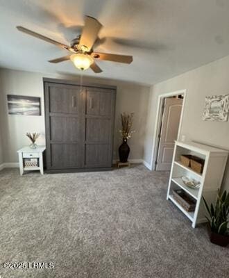 carpeted bedroom featuring baseboards and a ceiling fan