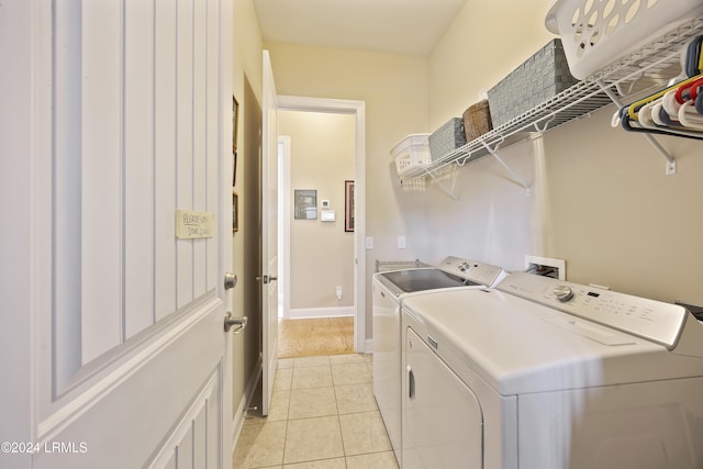 washroom with washing machine and dryer and light tile patterned floors