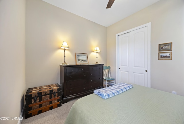 carpeted bedroom with ceiling fan and a closet