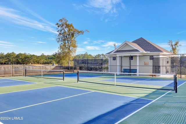 view of tennis court featuring basketball hoop