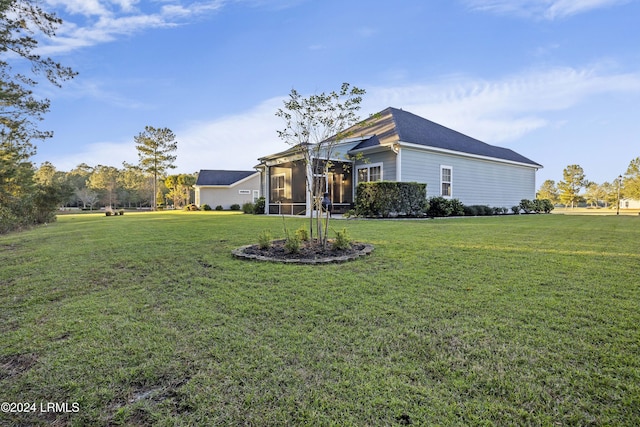 exterior space featuring a sunroom and a front lawn